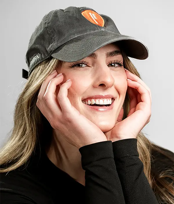 Woman smiling after cosmetic teeth whitening treatment