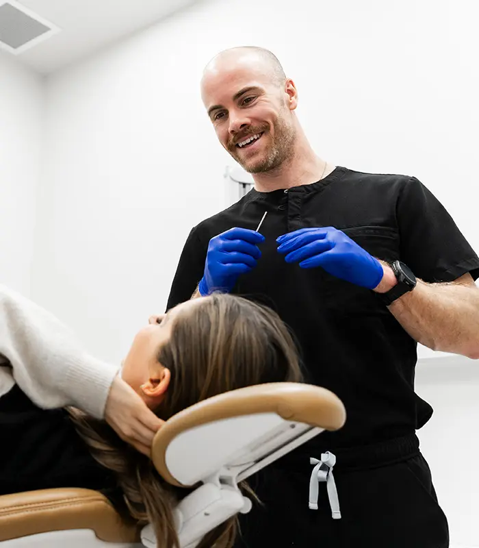 Dentist preparing for a dental Botox treatment while speaking with a patient at Landmark Dental
